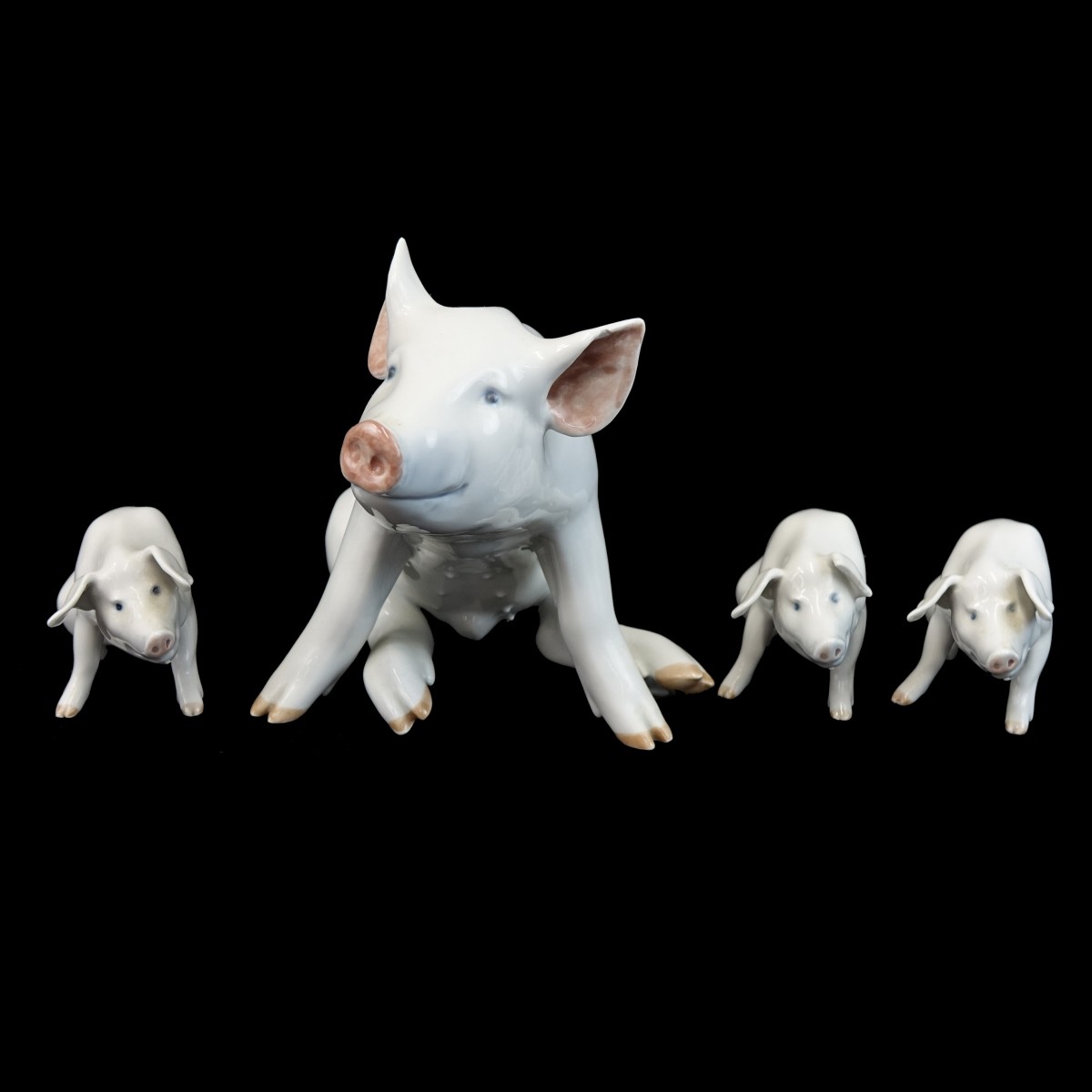 Four (4) Royal Copenhagen Porcelain Pig Figurines