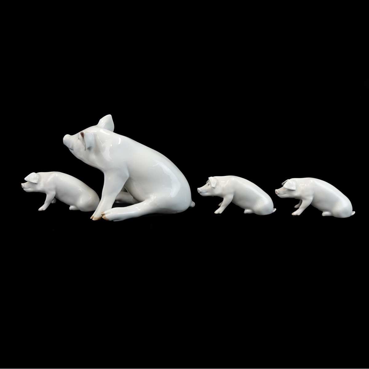 Four (4) Royal Copenhagen Porcelain Pig Figurines