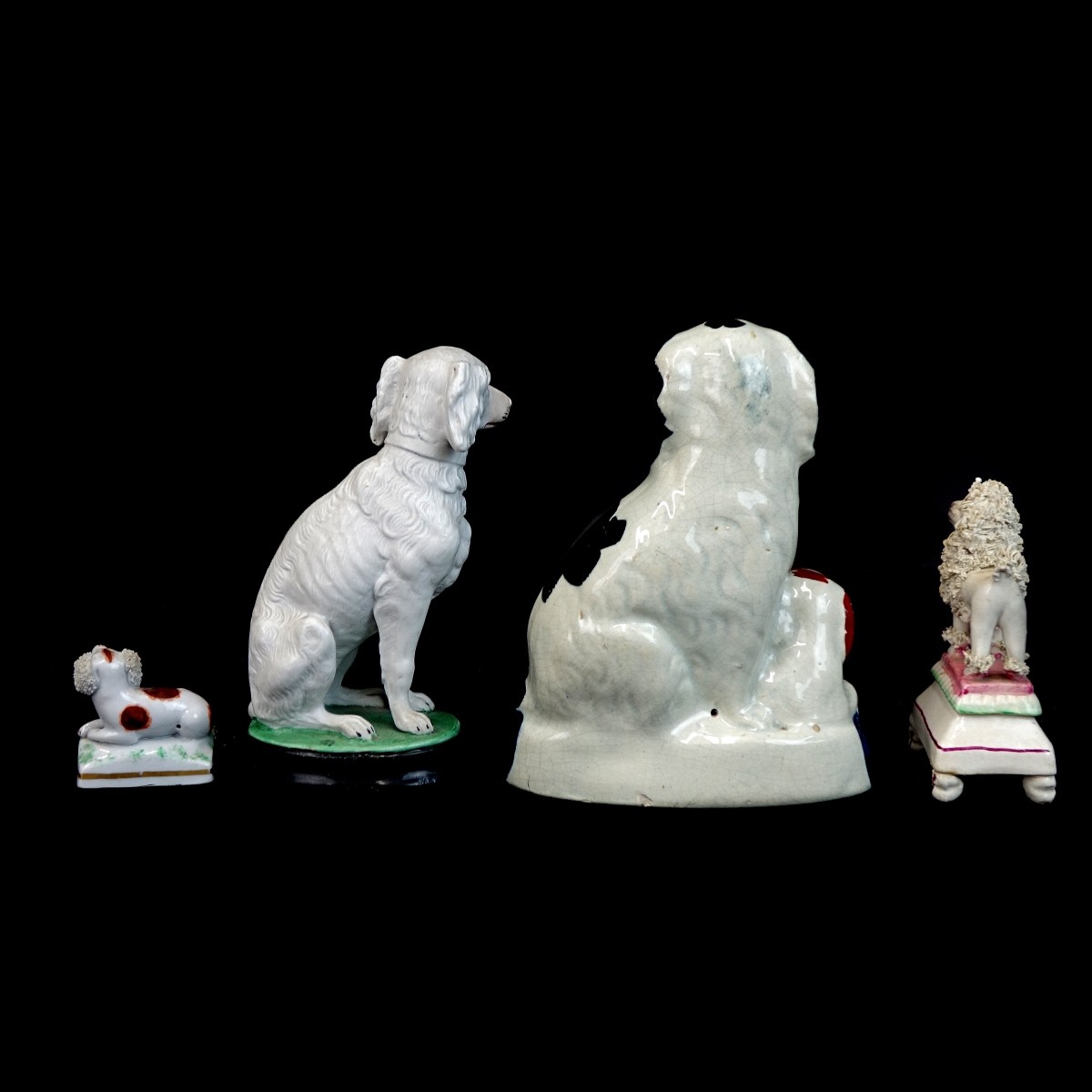 Four (4) Porcelain Dog Figurines