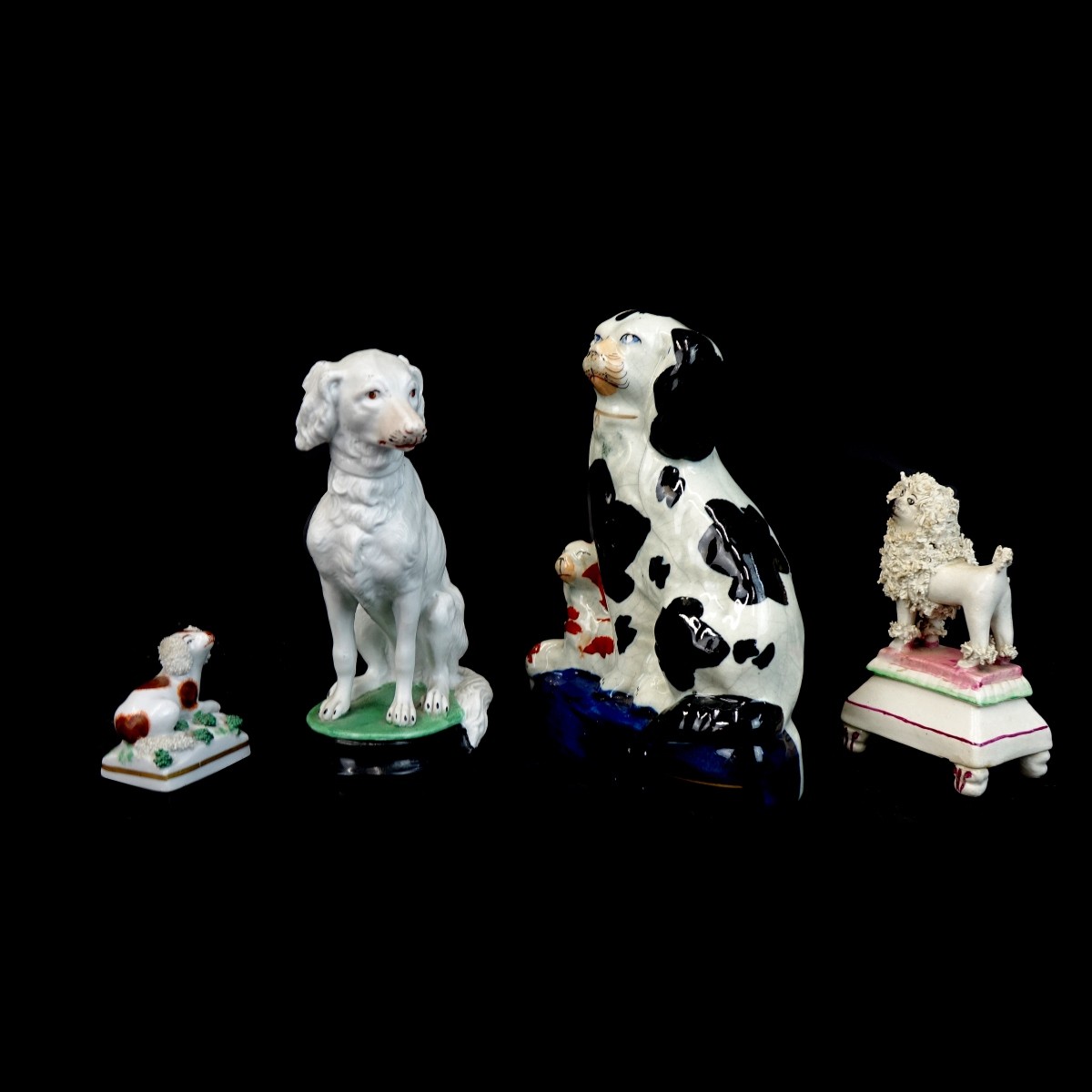 Four (4) Porcelain Dog Figurines