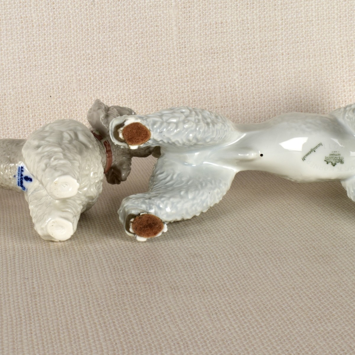 Two Porcelain Poodle Figurines