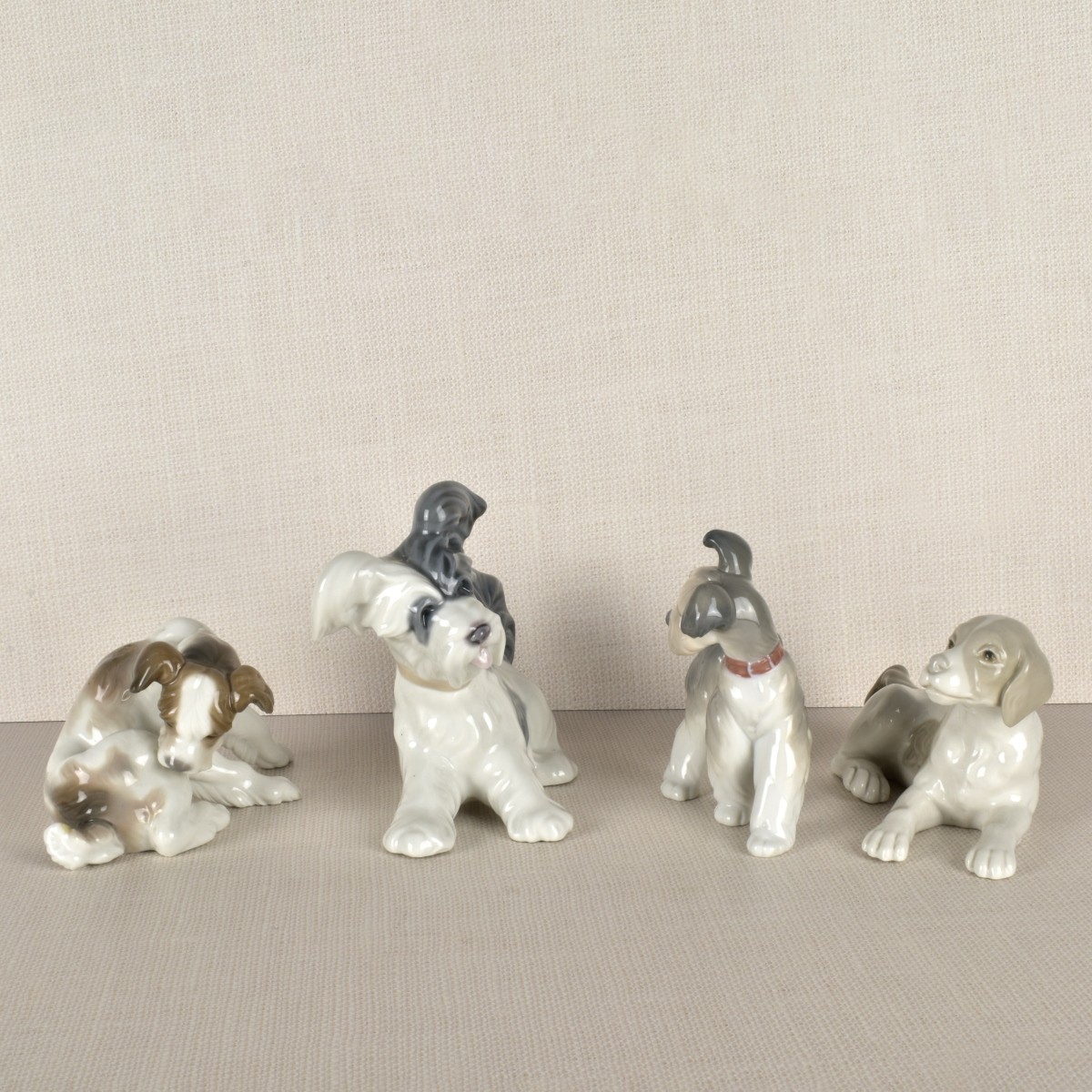 Four Lladro Porcelain Dog Figurines