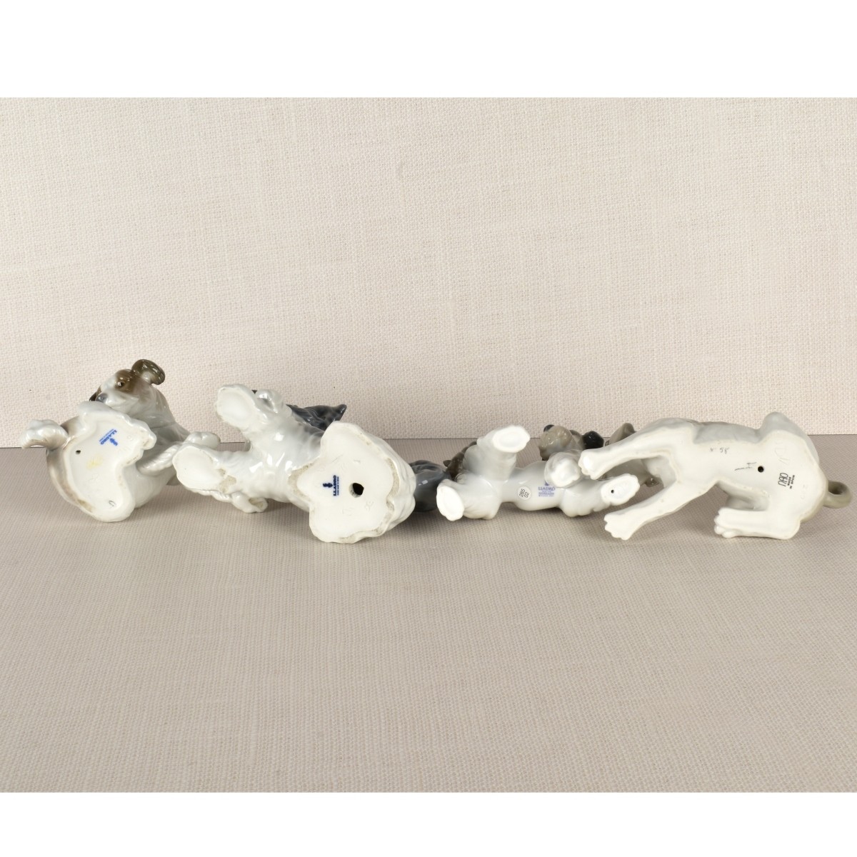 Four Lladro Porcelain Dog Figurines